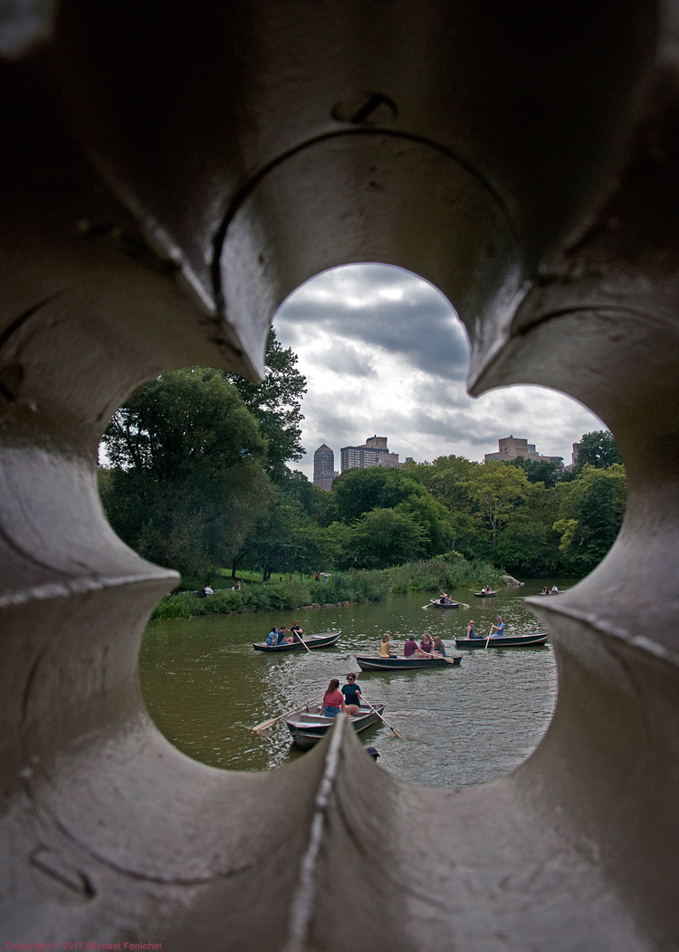 [View of Central Park pond through Bow Bridge]