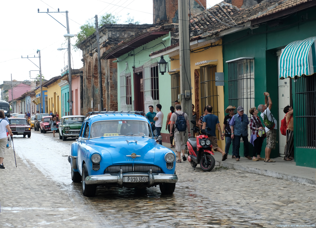 Blue car on colorful street